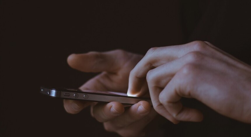 Hands using an App or texting on mobile phone