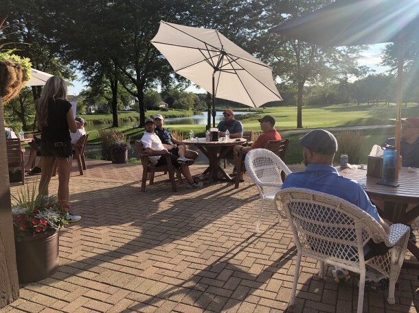 people dining on patio at Orchard Valley Golf Course